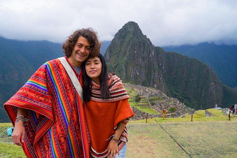 Classic photo of a tourist couple in Machu Picchu