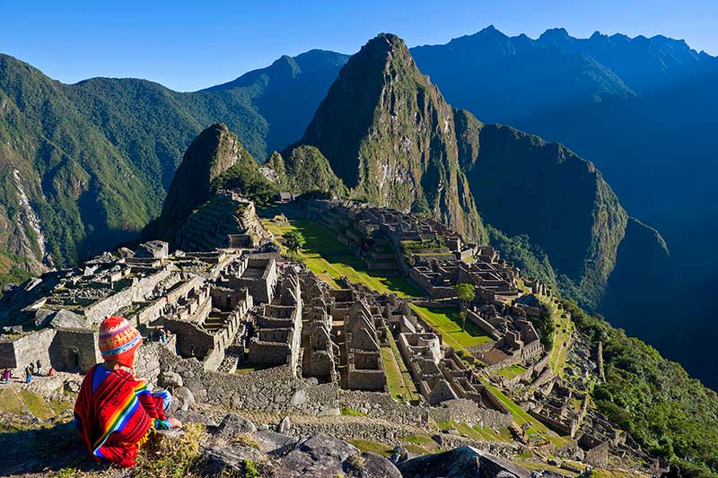 Child observing the Inca citadel of Machu Picchu