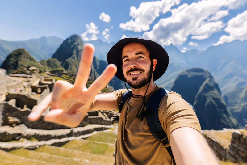 Happy young man taking a selfie in Machu Picchu