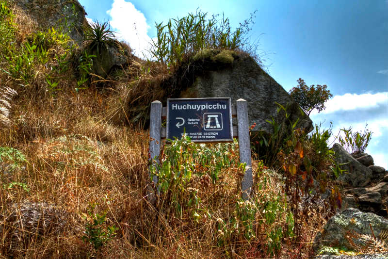 Sign on the road to Huchuy Picchu with information on altitude.