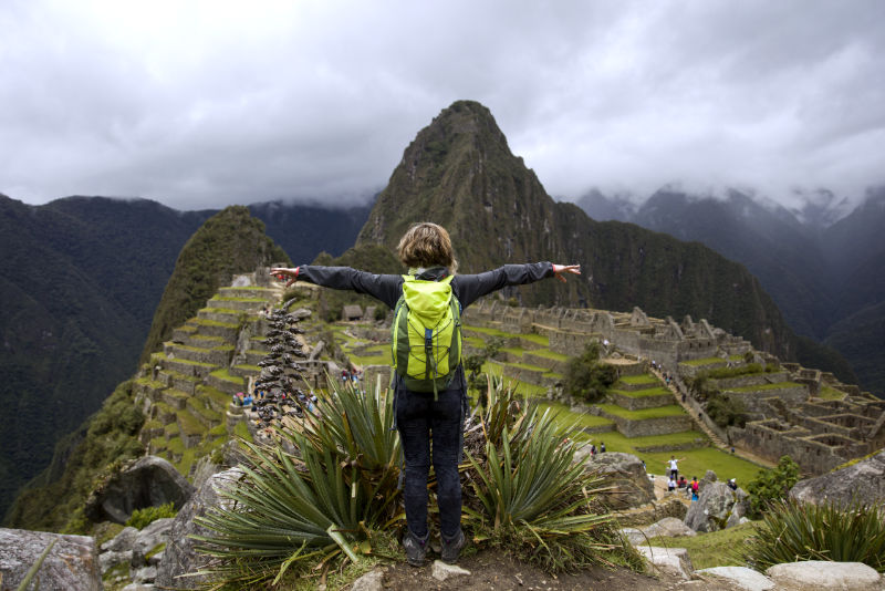 Tourist enjoying his view of Machu Picchu