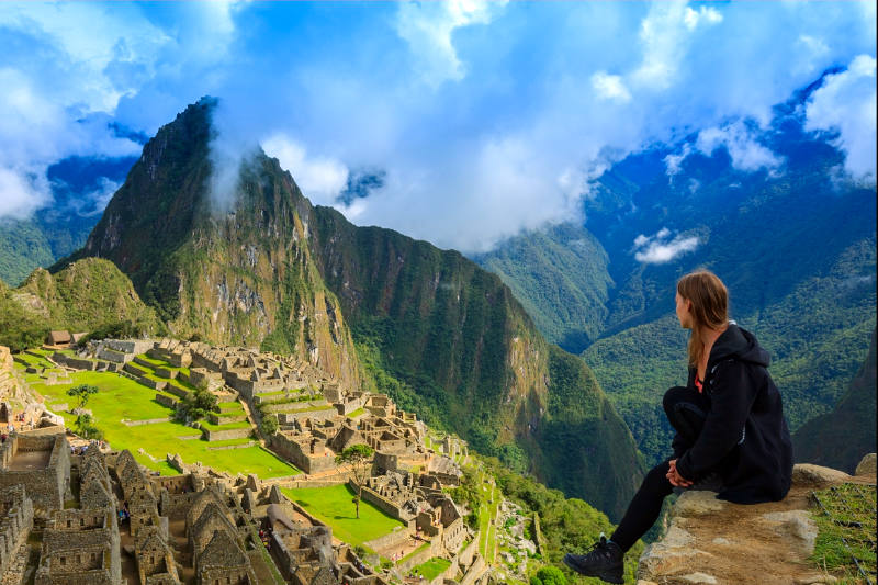 Seated tourist observing the Inca citadel