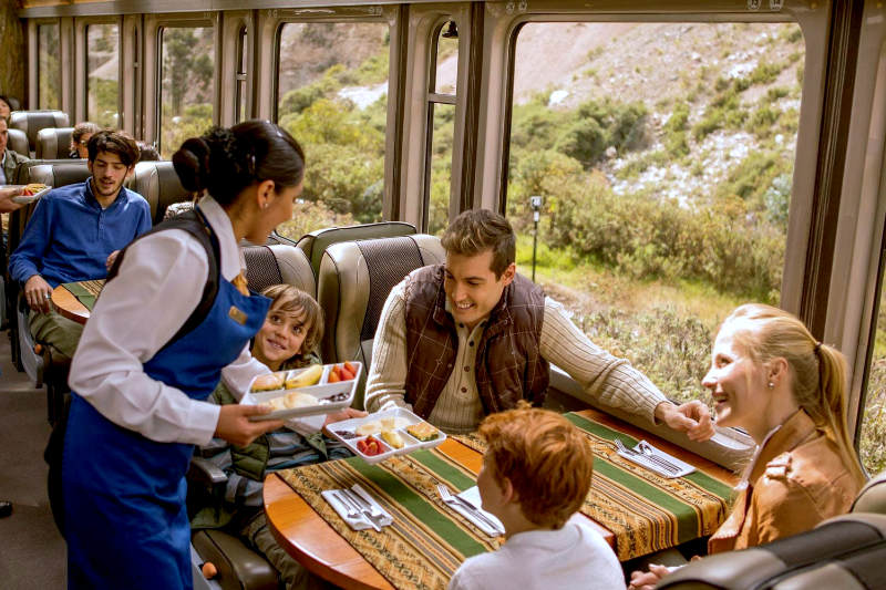 Family of tourists traveling by train to Machu Picchu