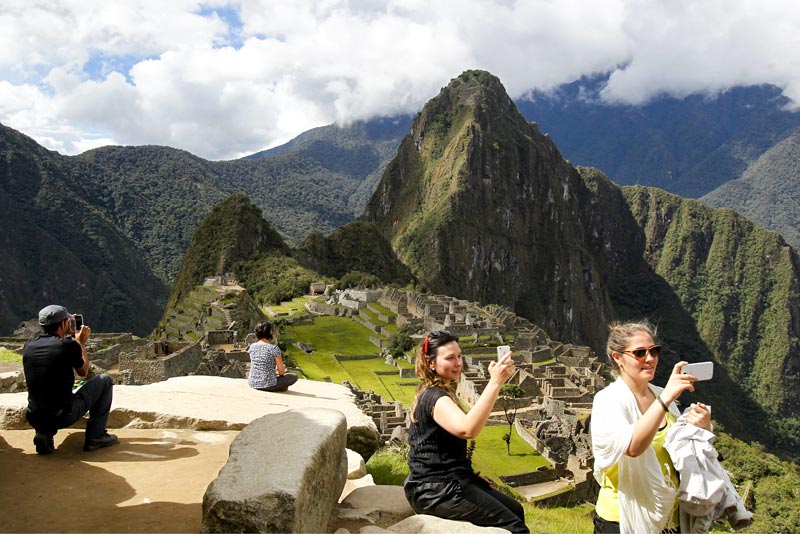 Tourists taking photos at Machu Picchu