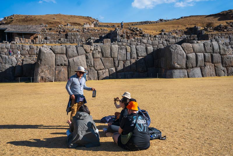 Guide explaining about the archaeological site of Sacsayhuaman