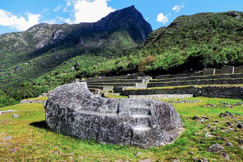 The Funerary Rock of Machu Picchu, in the background the Machu Picchu Mountain