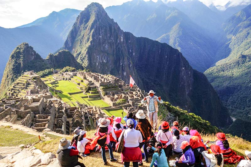 Students listening to the guide's explanation in Machu Picchu