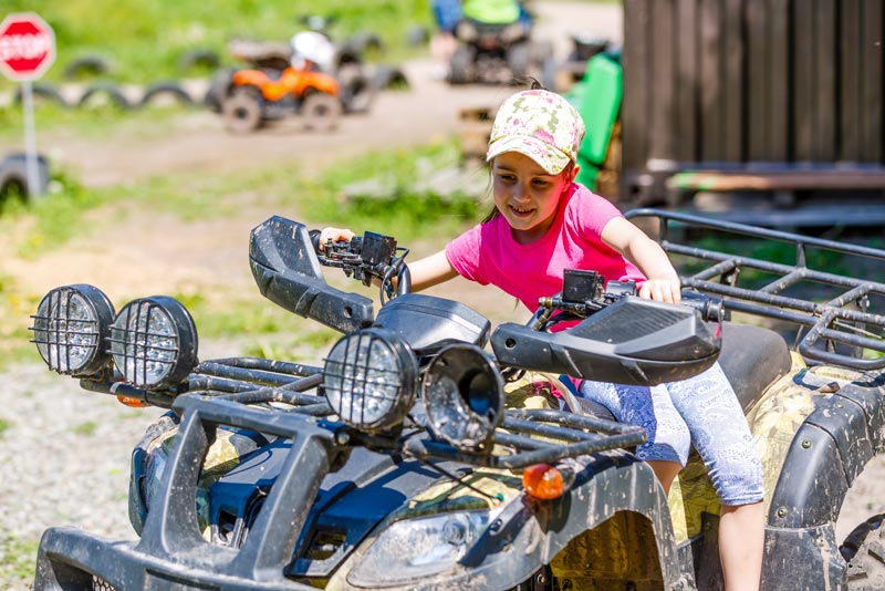 Girl pretending to drive a four-wheeler