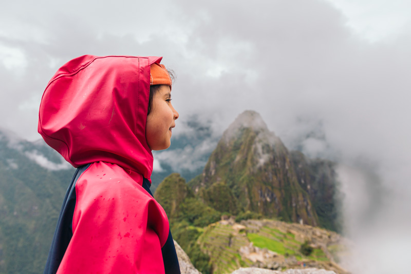 Girl visiting Machu Picchu on a cloudy day