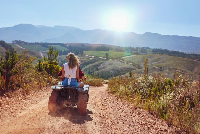 Tourist couple heading to the Abode of the Gods on a quad bike