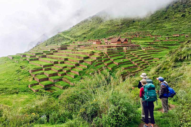 Touristes visitant le site archéologique de Huchuy Qosqo