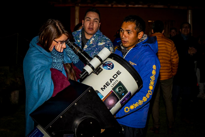 People observing stars through telescope