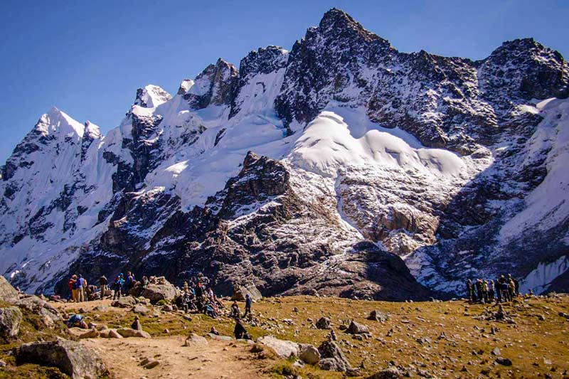 Tourists at the foot of the Salkantay snowy mountain